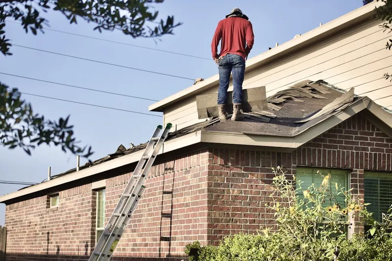 Professional roofer working on a residential roof in Pleasant Lake